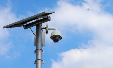 CCTV camera on bright blue sky background,  Concept. 24 hour day and night security