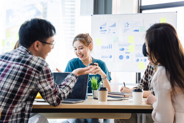 Fototapeta premium Young colleagues having great business conversations in a modern coworking office. Teamwork concept. Horizontal blurry background. Fireworks.