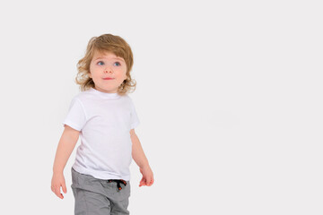 Surprise on the face of a small child on a white background. Copy space . High quality photo
