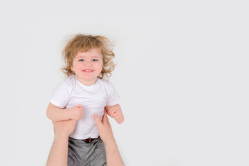 Dad throws a laughing child up. White background. Copy space . High quality photo