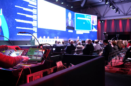 Technician handling the lights at a conference	