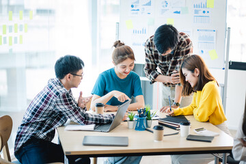 Young colleagues having great business conversations in a modern coworking office. Teamwork concept. Horizontal blurry background. Fireworks.