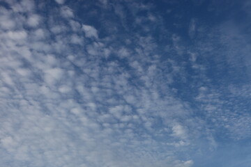 White cumulus clouds in a blue sky with a place for text, Concept lettering and advertising,