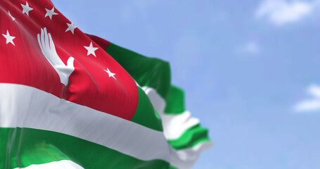 Detail of the national flag of Abkhazia waving in the wind on a clear day