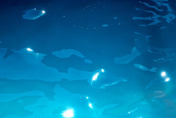 blue water wave texture background. Rippled water. Shiny purple and blue water surface.