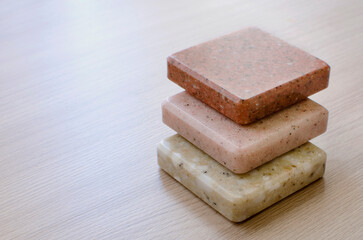 Samples of decorative artificial stone, close-up. Stone samples for kitchen countertops or bathroom, modern interior design. Place for text, copyspace.