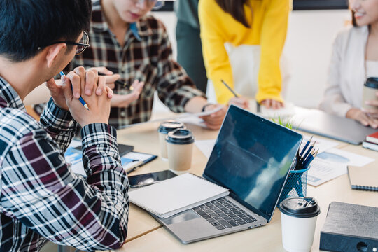Young colleagues having great business conversations in a modern coworking office. Teamwork concept. Horizontal blurry background. Fireworks.