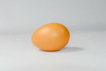 eggs separated on chopping board white background, one egg.
