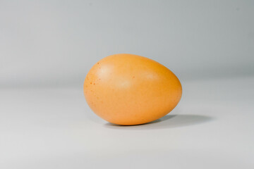 eggs separated on chopping board white background, one egg.