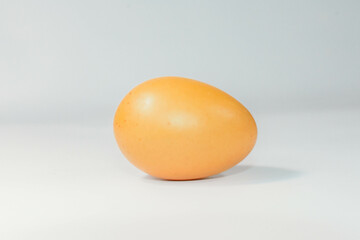 eggs separated on chopping board white background, one egg.