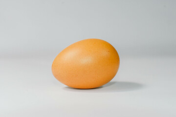 eggs separated on chopping board white background, one egg.