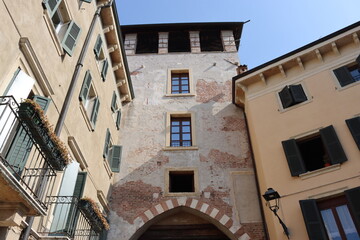 Fototapeta na wymiar Verona, Italy-March 19, 2022: Beautifull old buildings of Verona. Typical architecture of the medieval period. Aerial view to the city with blue sky in the background.