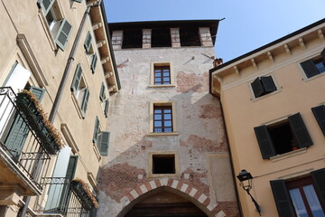 Verona, Italy-March 19, 2022: Beautifull old buildings of Verona. Typical architecture of the medieval period. Aerial view to the city with blue sky in the background.