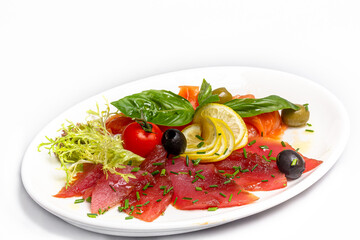 Tuna and salmon sashimi with lemon, olives and basil