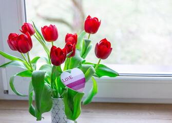 bouquet of tulips at home on the window sill