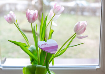 Pink tulips in a vase at home. Bouquet for Mothers day, home decoration	