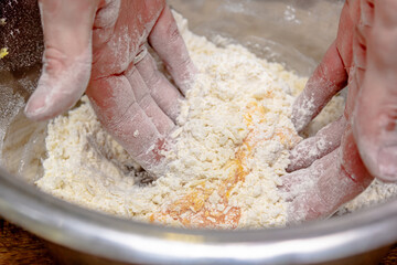 The cook prepares dough from flour and eggs