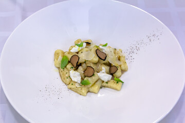 The Italian dish gnocchi with truffle is on the plate