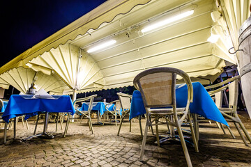 table and chairs at a sidewalk cafe