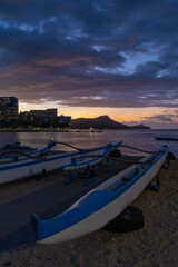 Fototapeta na wymiar Sunrise over Waikiki beach with an outrigger