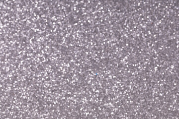 blurred close-up photo of silver sand, shot with depth of field, colored sand paper textured background