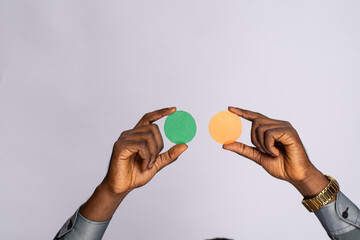 black man holding blank small cardboard circles for emoji face