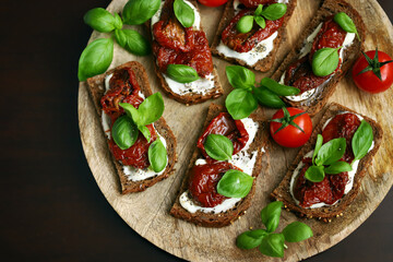Selective focus. Macro. Healthy toast with sun-dried tomatoes and basil. Italian food. Mediterranean snack.