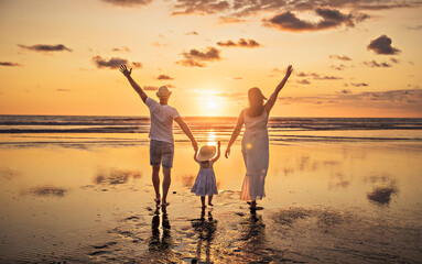 Fototapeta premium Family on the beach concept, Caucasian family playing and carrying his daughter on the tropical beach in sunset.