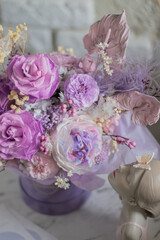 A mix of pink peonies with purple and pink roses on coffee table. Bouquet of tenders peonies a girl for mother's day, valentine's day, Woman's day 8 march.