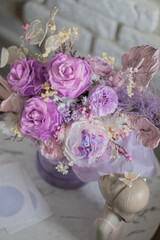 A mix of pink peonies with purple and pink roses on coffee table. Bouquet of tenders peonies a girl for mother's day, valentine's day, Woman's day 8 march.