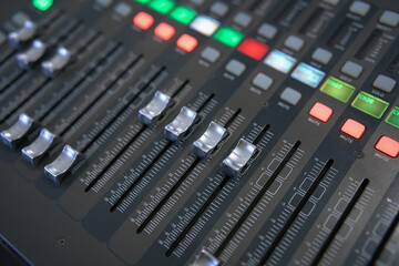 Professional audio mixing console. ​Mixer. Pro audio mixing board faders and knobs. Static shot of multi-track music recording equipment faders and sliders. 