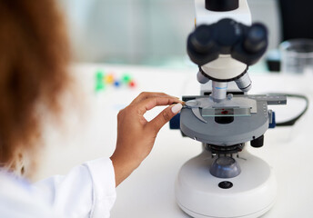 Fototapeta na wymiar Time to inspect this sample. Cropped shot of a young female scientist analysing a sample in the lab.