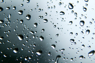 Raindrops on window pane on a cold day of winter