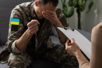 Ukrainian man warrior dressed in a military pixel uniform the yellow-blue flag of Ukraine