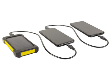 two smartphones connected by a wire to each other are charged from a solar battery