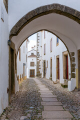 old city gate and cobblestone street leading into the walled old city center of Marvao