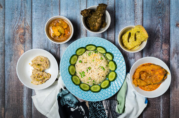 Assorted indian food decoration on the dark wooden background. Dishes and appetizers of indian cuisine.