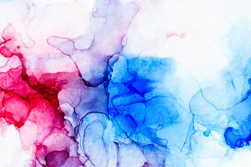 Macro close-up of red and blue alcohol ink layers and splashes, abstract background. Fluid ink, colorful full frame textured background. Vibrant colors. Art for design.
