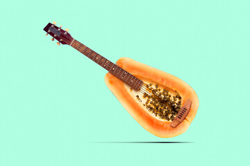 Metaphor photo picture of guitar on papaya fruit place raw crazy amazing sound quality conceptual color background