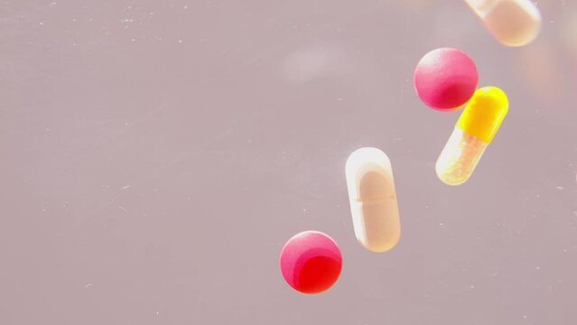 many colored pills, medicine, capsules with powder falls down, bounce, concept of maintaining health, medication treatment, vitamins, dietary supplements, drug addiction, slow motion