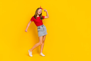 Fototapeta na wymiar Full size photo of carefree cheerful teen female having fun dancing discotheque isolated on yellow color background
