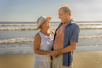 Senior Couple Enjoying Beautiful Sunset on the Beach