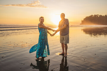 Senior Couple Enjoying Beautiful Sunset on the Beach