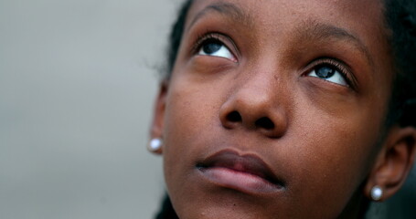 Happy black African teen girl opening eyes outside smiling
