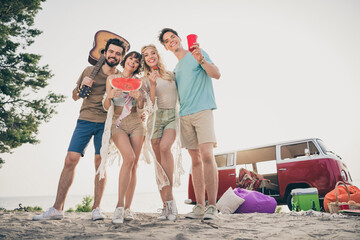 Photo of funny best fellows group have relaxing fun camping wear boho outfit nature seaside beach outside