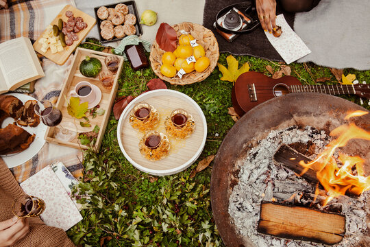 Overhead view of food at picnic around fire pit