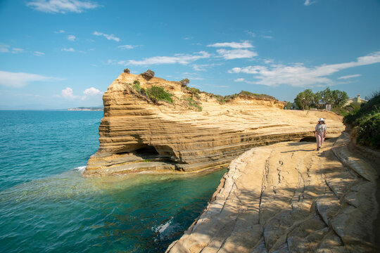 Greece, Corfu island, Sidari, Woman walking on cliff by Canal DAmour