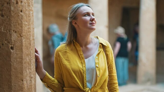 Woman is on an excursion with a tourist group.