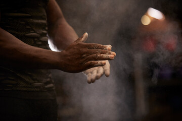 Close-up of mans hands with chalk in gym