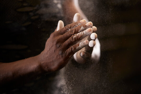 Close-up of mans hands with chalk in gym